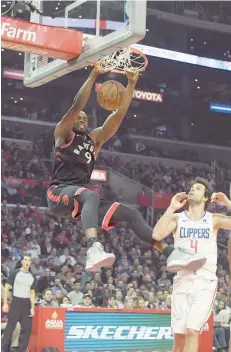  ?? — USA Today Sports ?? Toronto Raptors forward Serge Ibaka (9) dunks the ball in the second half as LA Clippers guard Milos Teodosic (4) watches at Staples Center. The Raptors defeated the Clippers 123-99.