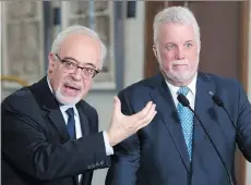  ?? JACQUES BOISSINOT/THE CANADIAN PRESS ?? Quebec Premier Philippe Couillard, right, and Finance Minister Carlos Leitão announced plans Wednesday to trim the provincial debt by $10 billion by 2022-23.