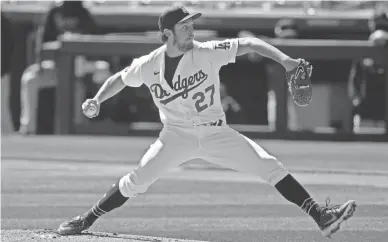  ?? ROSS D. FRANKLIN/AP ?? Dodgers starting pitcher Trevor Bauer throws against the Rockies during a spring training game March 1 in Phoenix. Bauer is the highest-paid MLB player in 2021 at $38 million.