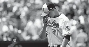  ?? PATRICK SEMANSKY/ASSOCIATED PRESS ?? Orioles starting pitcher Ubaldo Jiménez wipes his face as he walks off the field after allowing the Cubs to score four runs in the second inning. Jiménez failed to pitch out of the fourth inning for the fifth time this season.