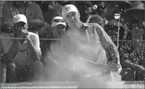  ??  ?? Paying close attention: Jordan Spieth watches his hit out of a bunker at the seventh hole during the third round of the Masters golf tournament Saturday, in Augusta, Ga.