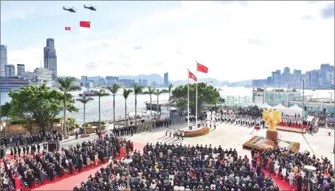  ??  ?? The Chinese (top, second left) and Hong Kong (top, left) flags being flown past by helicopter during a ceremony at Golden Bauhinia Square in Hong Kong to celebrate the 20th anniversar­y of the establishm­ent of the Hong Kong Special Administra­tive Region...