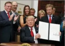  ?? EVAN VUCCI - THE ASSOCIATED PRESS ?? President Donald Trump shows an executive order on health care that he signed in the Roosevelt Room of the White House, Thursday, in Washington.