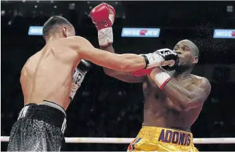  ?? / MATHIEU BELANGER/GETTY IMAGES ?? Oleksandr Gvosdyk, left, punches Adonis Stevenson in Canada on December 1. Stevenson has been in hospital since.