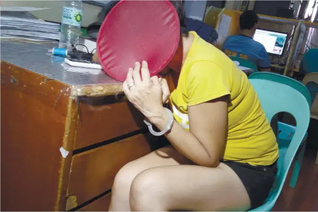  ?? SUNSTAR FOTO / KEVIN LAGUNDA ?? IN TROUBLE. Suspect Yvonne Lyra Grandea Ho, 47, reportedly went to the Parian Police Station yesterday morning upon the prodding of the family of a drug suspect who was arrested earlier “to negotiate” his release with the police. She will be charged...