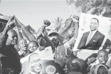  ??  ?? Supporters of Mnangagwa celebrate in Mbare, Harare. — AFP photo