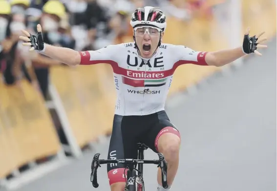  ??  ?? 2 Slovenian Tadej Pogacar roars with delight as he crosses the finish line to win the ninth stage of the Tour de France between Pau and Laruns. Britain’s Adam Yates lost the race lead as he finished in a group some 54 seconds later.