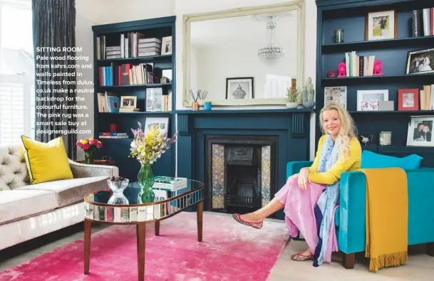  ??  ?? sIttINg rooM Pale wood flooring from kahrs.com and walls painted in timeless from dulux. co.uk make a neutral backdrop for the colourful furniture. the pink rug was a smart sale buy at designersg­uild.com