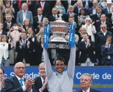  ??  ?? Rafael Nadal lifts his 11th Barcelona Open trophy in Spain while staying unbeaten on the clay surface for 46 straight sets