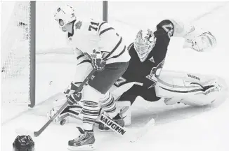  ?? GENE J. PUSKAR/THE ASSOCIATED PRESS ?? Penguins goalie Jeff Zatkoff stops Leafs forward David Clarkson during a shootout in Pittsburgh on Wednesday. After leading by three goals, the Leafs allowed the Penguins to come back and win the game.