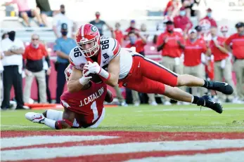  ?? AP Photo/Michael Woods ?? ■ Georgia tight end John FitzPatric­k (86) dives into the end zone past Arkansas defender Jalen Catalon (1) to score a touchdown during the second half of an NCAA college football game Saturday in Fayettevil­le, Ark.