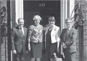  ?? THE ASSOCIATED PRESS ?? Britain’s Prime Minister Theresa May, second left, greets Democratic Unionist Party leader Arlene Foster, second right, DUP deputy leader Nigel Dodds, left, and member of parliament Jeffrey Donaldson, outside 10 Downing Street in London on Monday.