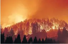  ?? [NOAH BERGER/ASSOCIATED PRESS FILE PHOTO] ?? The Glass Fire burns a hillside above Silverado Trail on Sept. 27 in St. Helena, Calif.