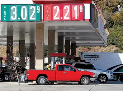  ?? Arkansas Democrat-Gazette/THOMAS METTHE ?? Drivers gas up Wednesday at a filling station on Pershing Boulevard in North Little Rock. Falling oil prices are good for consumers but not so good for small oil production firms.