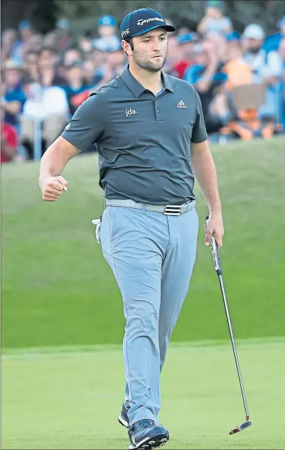  ??  ?? Jon Rahm celebrates holing a 20-foot putt on the last hole at Wentworth