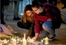  ?? PHOTO: GETTY IMAGES ?? People attend a candlelit vigil at Albert Square in Manchester on Tuesday night, to honour the victims of the terror attack at Manchester Arena the night before.