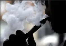  ?? AP PHOTO/NAM Y. HUH, FILE ?? In this April 23, 2014, file photo, a man smokes an electronic cigarette in Chicago.