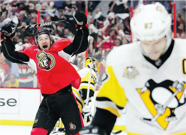  ?? PHOTOS: WAYNE CUDDINGTON / POSTMEDIA NEWS ?? Mark Stone celebrates Zack Smith’s first-period goal as Sidney Crosby skates by in Game 3 of the Eastern Conference final Wednesday night.