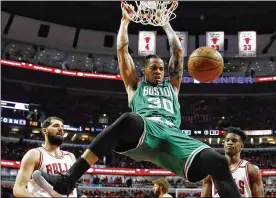  ?? NAM Y. HUH / AP ?? Gerald Green dunks against the Bulls’ Nikola Mirotic (left) and Jimmy Butler as the Celtics roll to a clinching victory in Game 6 of the first-round series.