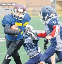  ?? JASON MALLOY/THE GUARDIAN ?? Running back Carissa Zettle broke a few tackles en route to scoring the winning touchdown Saturday in the Papa John’s Football P.E.I. under-12 championsh­ip game in Cornwall.