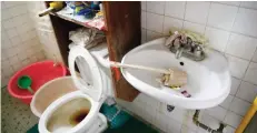  ?? — AP ?? MABALACAT: Underwear is wedged behind the faucet of the bathroom sink inside the home of suspected child webcam cybersex operator, David Timothy Deakin.