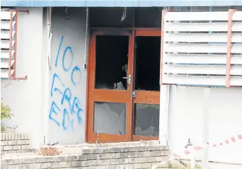  ?? Picture: BRIAN WITBOOI ?? DAMAGED BUILDING: The entrance to the procuremen­t building at NMMU’s south campus after petrol bombs were thrown into the office block at the weekend. Graffiti was sprayed on the walls, saying ‘ANC Must Fall’, ‘F**k You’, ‘Zuma Must Fall’ and ‘100%...