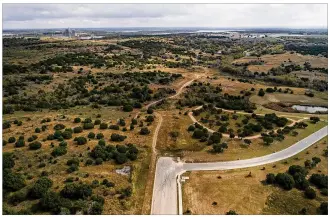  ?? JAY JANNER / AMERICAN-STATESMAN ?? Plans show visions of a mixed-use, mixed-income developmen­t sprinkled with single-family homes, park space, a medical clinic and a rail station rising on this land, about 208 acres in Northeast Austin owned by the city.