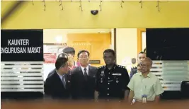  ?? VINCENT THIAN/ASSOCIATED PRESS ?? North Korean Ambassador to Malaysia Kang Chol, second from left, prepares to leave the forensic department at a hospital in Kuala Lumpur, Malaysia.