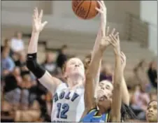  ??  ?? Holy Family senior Erin Mann (No. 12) battles for a rebound in Lady Tigers’ recent double-digit win over Concordia. Mann led the Tigers with 29 points. (photo courtesy HFU Athletics)