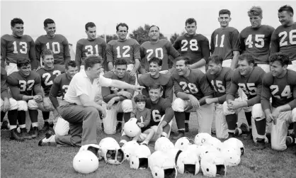  ?? Photograph: AP ?? Bert Bell talks to the Philadelph­ia Eagles during his time as the team’s head coach. His son Bert Jr sits on a player’s lap.