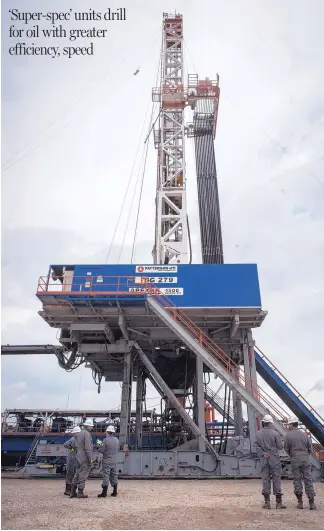  ?? MARIE D. DE JESUS/HOUSTON CHRONICLE ?? This Patterson-UTI APEX-XK 1500 oil rig drill works a well near College Station, Texas. Drillers are paying more and signing longer contracts for monster rigs that drill wells much faster than older models.