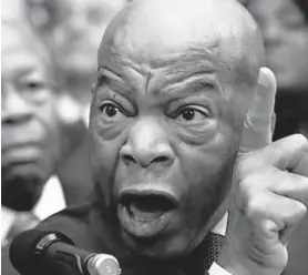  ?? ALEX WONG/GETTY ?? Rep. Elijah Cummings, D-Md., listens as Rep. John Lewis, D-Ga. speaks Jan. 14, 2019.