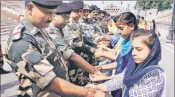  ?? PTI ?? Women tie rakhis on the wrists of BSF jawans on the occasion of Rakshaband­han at AttariWaga­h border post near Amritsar on Sunday.