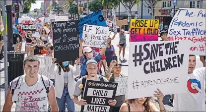  ?? Kent Nishimura Los Angeles Times ?? QANON conspiracy theorists at a rally in Hollywood to “save the children” from satanic pedophiles in the government.