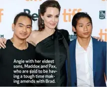  ??  ?? Angie with her eldest sons, Maddox and Pax, who are said to be having a tough time making amends with Brad.