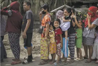  ?? Ezra Acayan / Getty Images ?? Volcano evacuees line up for relief supplies in the village of San Guillermo in Batangas province. President Rodrigo Duterte is to check conditions in the hardhit province Monday.