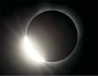  ?? DON RYAN — THE ASSOCIATED PRESS ?? The moon almost eclipses the sun Monday during a near total solar eclipse, as seen from Salem, Ore.