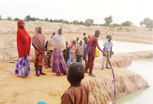  ??  ?? Children fetching water from the pond