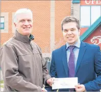  ?? SUBMITTED PHOTO ?? Neal Connaughto­n (left), son of Robert Connaughto­n Sr., presents thirdyear UPEI business student Colin Trewin with the inaugural Robert J. Connaughto­n Sr. Memorial Award.