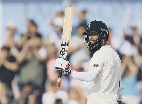  ??  ?? 0 England’s Moeen Ali acknowledg­es the applause after reaching his half century on day four.
PICTURE: NIGEL FRENCH/ PA