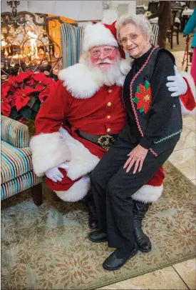  ?? WILLIAM HARVEY/RIVER VALLEY & OZARK EDITION ?? Rick Sublett of Conway, aka Santa Rick, takes a picture with Sue Lynn on his lap at The Manor assisted-living community in Little Rock. Sublett has been making appearance­s as Santa for about 10 years, to the young and young at heart.