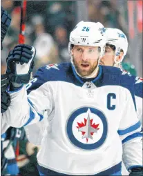  ?? CP PHOTO ?? In this April 15, 2018, file photo, Winnipeg Jets forward Blake Wheeler (26) is congratula­ted after scoring a goal against the Minnesota Wild in the first period of an NHL hockey game.