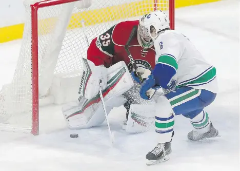  ?? THE ASSOCIATED PRESS ?? Vancouver Canucks forward Brock Boeser, who was signed the day before, scores against Minnesota Wild goalie Darcy Kuemper as Boeser made his NHL debut in his home state Saturday in St. Paul, Minn. Boeser had finished his NCAA career the previous night...