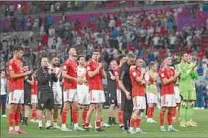  ?? (AFP) ?? Wales’ players applaud the crowd after being defeated 3-0 in the FIFA World Cup Qatar 2022 Group B match against England at the Ahmad Bin Ali Stadium on Tuesday.