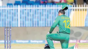  ?? AP ?? South Africa’s Quinton de Kock kneels in support of the Black Lives Matter movement ahead of the Twenty20 World Cup cricket match between South Africa and Sri Lanka in Sharjah, United Arab Emirates, yesterday.