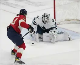  ?? PHOTOS BY WILFREDO LEE — THE ASSOCIATED PRESS ?? Panthers left wing Ryan Lomberg (94) attempts a shot at Sharks goaltender Kaapo Kahkonen (36) during the second period on Thursday in Sunrise, Fla.