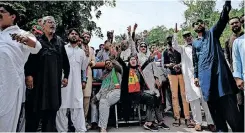  ?? | AFP ?? SUPPORTERS of Pakistan’s former prime minister Imran Khan stand guard outside his home in Islamabad, yesterday.