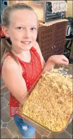  ?? PHILIP POTEMPA/POST-TRIBUNE ?? Columnist Philip Potempa’s greatniece Teaghan, 9, holds her mother’s signature recipe for baked macaroni and cheese.