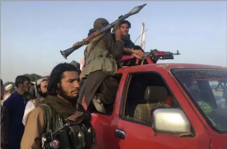  ?? RAHMAT GAL — THE ASSOCIATED PRESS ?? Taliban fighters ride in their vehicle Saturday in the Surkhroad district of Nangarhar province east of Kabul, Afghanista­n. They were there to celebrate a three-day cease fire marking the Islamic holiday of Eid al-Fitr when a suicide bomber struck.