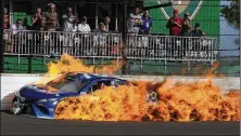  ?? GREG HUEY / ASSOCIATED PRESS ?? Martin Truex Jr.’s car burns after a crash with Kyle Busch during the Brickyard 400. As a result of the wreck, Truex finished 33nd and Busch 34th.